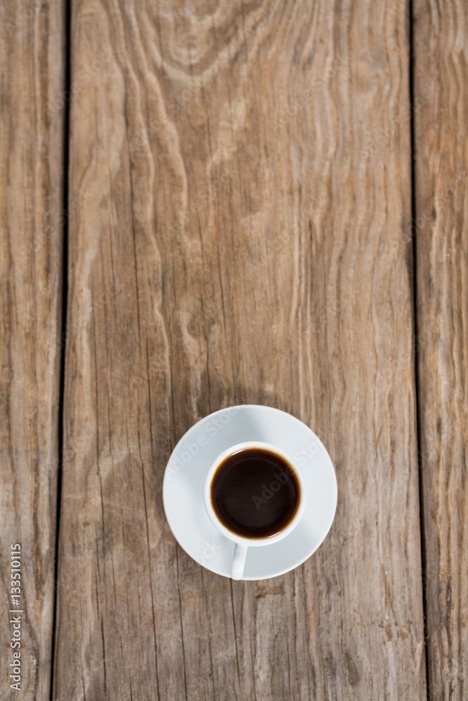 Cup of coffee with saucer on a wooden table Cup of coffee with saucer on a wooden table