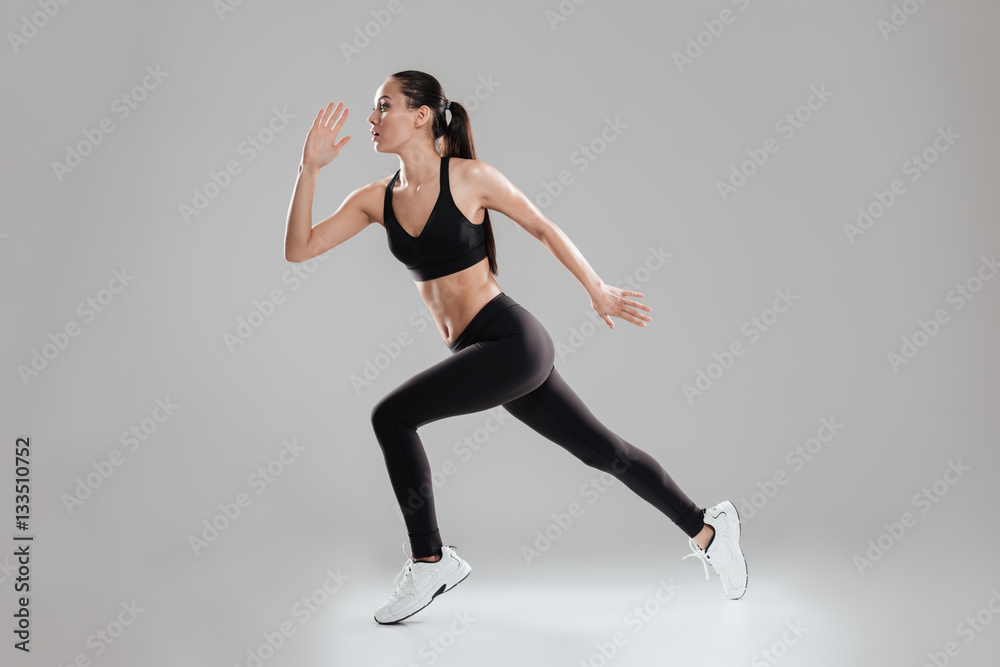 Sporting woman running in studio