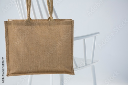Jute bag hanging on a white chair