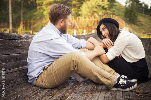 Beautiful hipster couple in love on a date outdoors in park havi photo