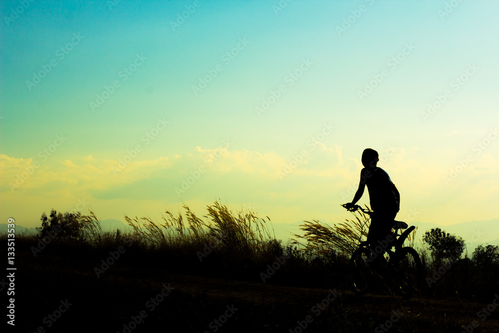 Silhouette of children cyclist riding Movement on the background