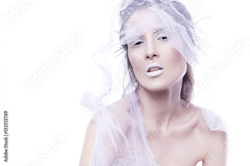 Brunette woman with creative make up in winter style with white