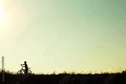 Silhouette of children cyclist riding Movement on the background