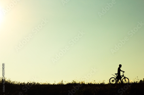 Silhouette of children cyclist riding Movement on the background