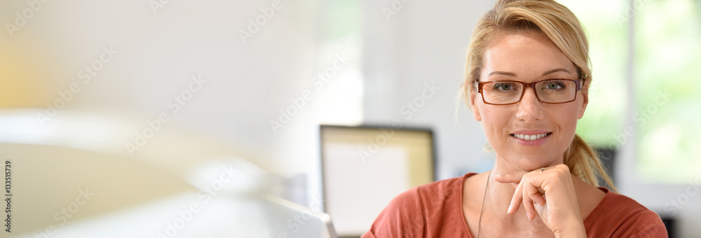 Fototapeta premium Portrait of beautiful blond woman with eyeglasses