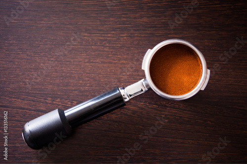 Grinded espresso in a coffee machine holder, top view