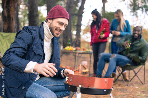 Man kindling fire on grill