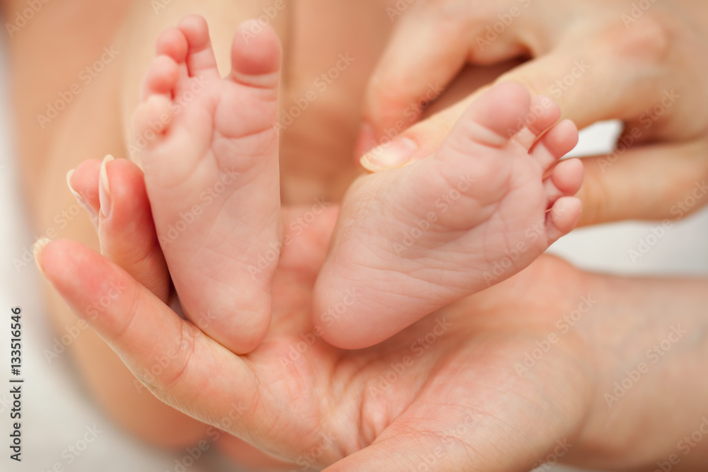 Small feet of baby new born that hold in her moms hand. Small feet of baby new born that hold in her moms hand.