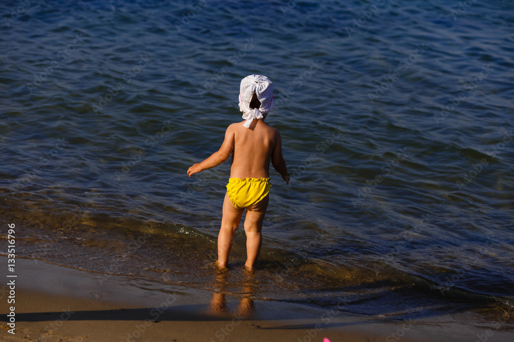 Girl runs along the beach summer