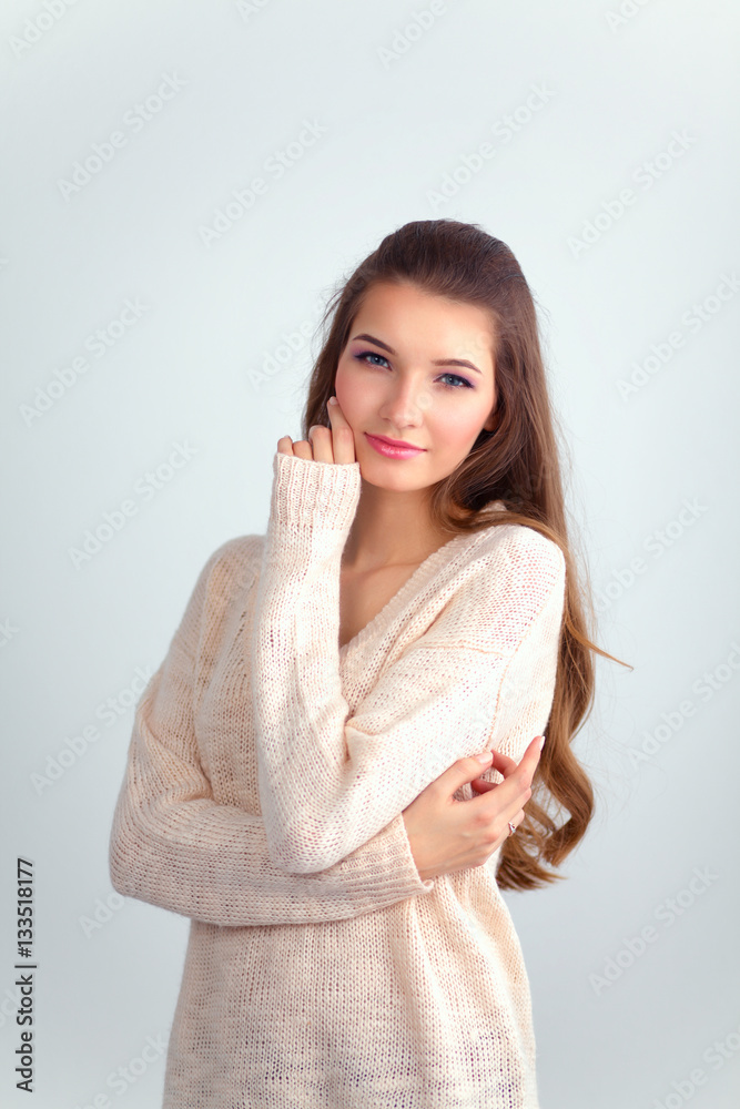 Young woman standing, isolated on gray background Young woman standing, isolated on gray background
