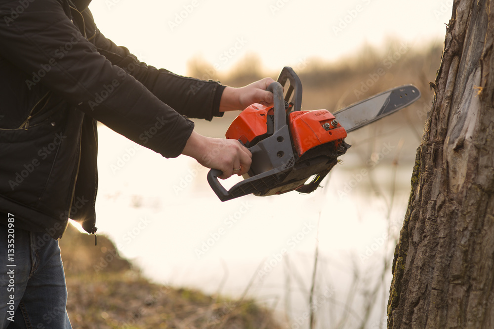 hands holding a chainsaw hands holding a chainsaw