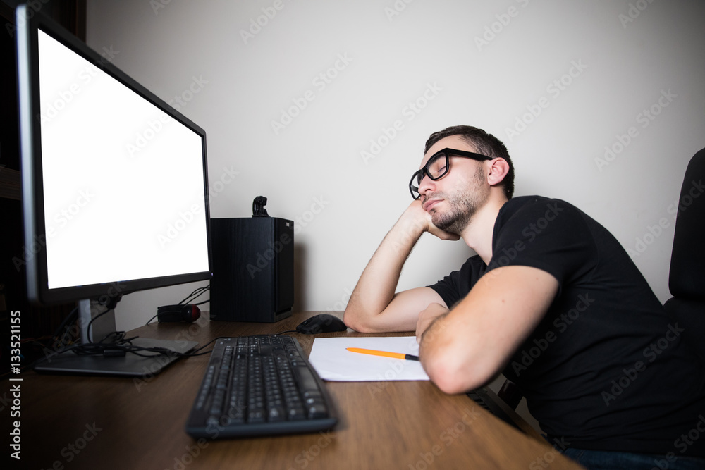 High angle view of tired hacker sleeping near computer at night High angle view of tired hacker sleeping near computer at night