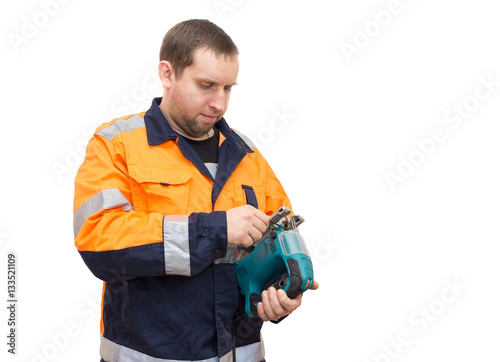 man in overalls with a jigsaw