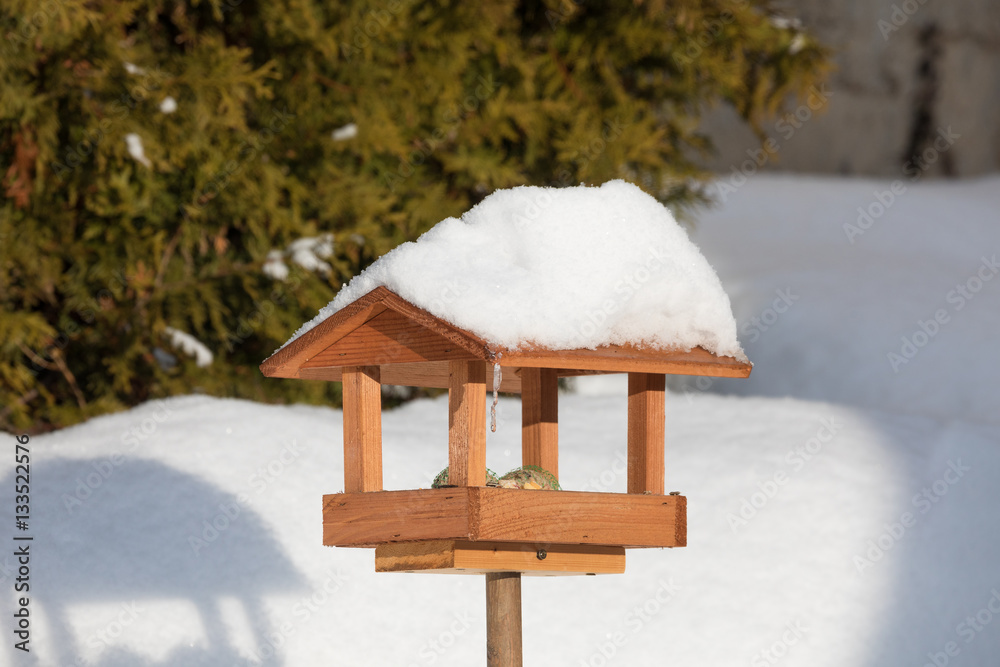 simple birdhouse in winter garden simple birdhouse in winter garden