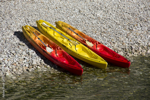 Three two-seater kayak on pebble beach in Dubrovnik in Croatia