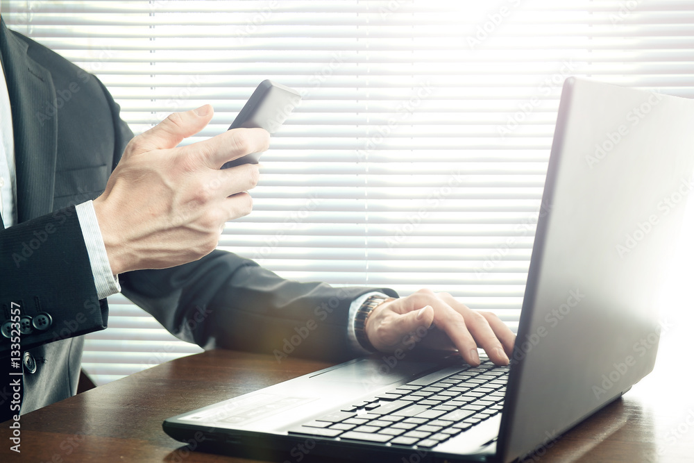 Business man working at office with laptop on his desk