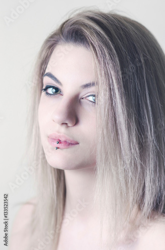 Beautiful caucasian young girl with lip piercing, studio shot
