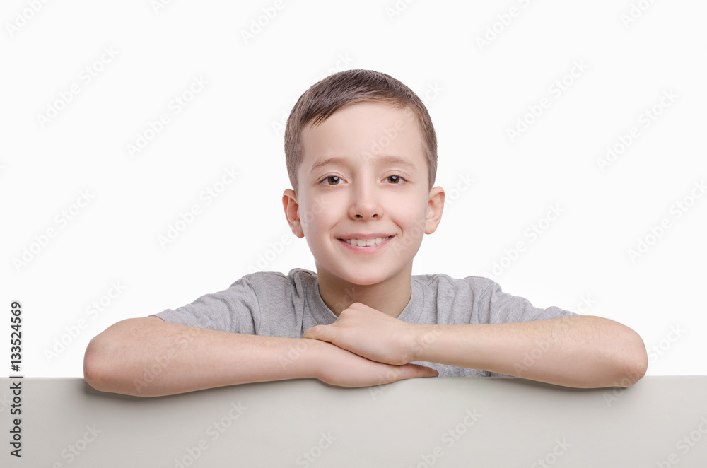 Your text here. Smiling boy standing near empty blank board. Your text here. Smiling boy standing near empty blank board.