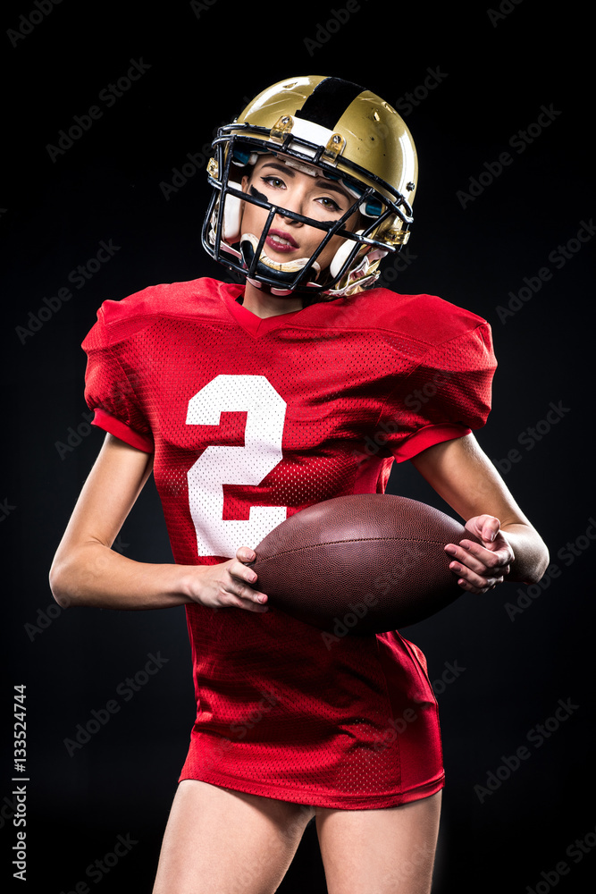 Female american football player in sportswear Female american football player in sportswear