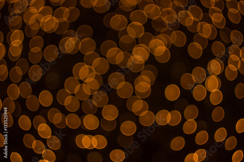 orange color lights bokeh on a dark background © losbkru