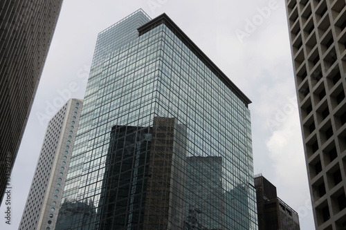 Modern abstract building in Hong Kong  geometric pattern of glass and concrete  design with reflection. Urban background