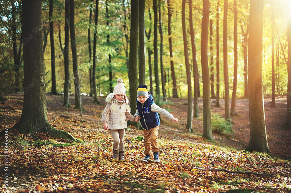 Two kids walking through the green forest Two kids walking through the green forest