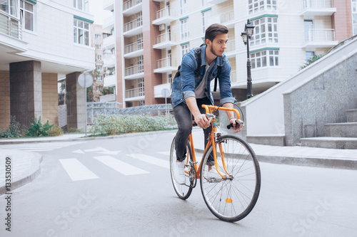 Fototapeta Naklejka Na Ścianę i Meble -  Man riding a bicycle outside