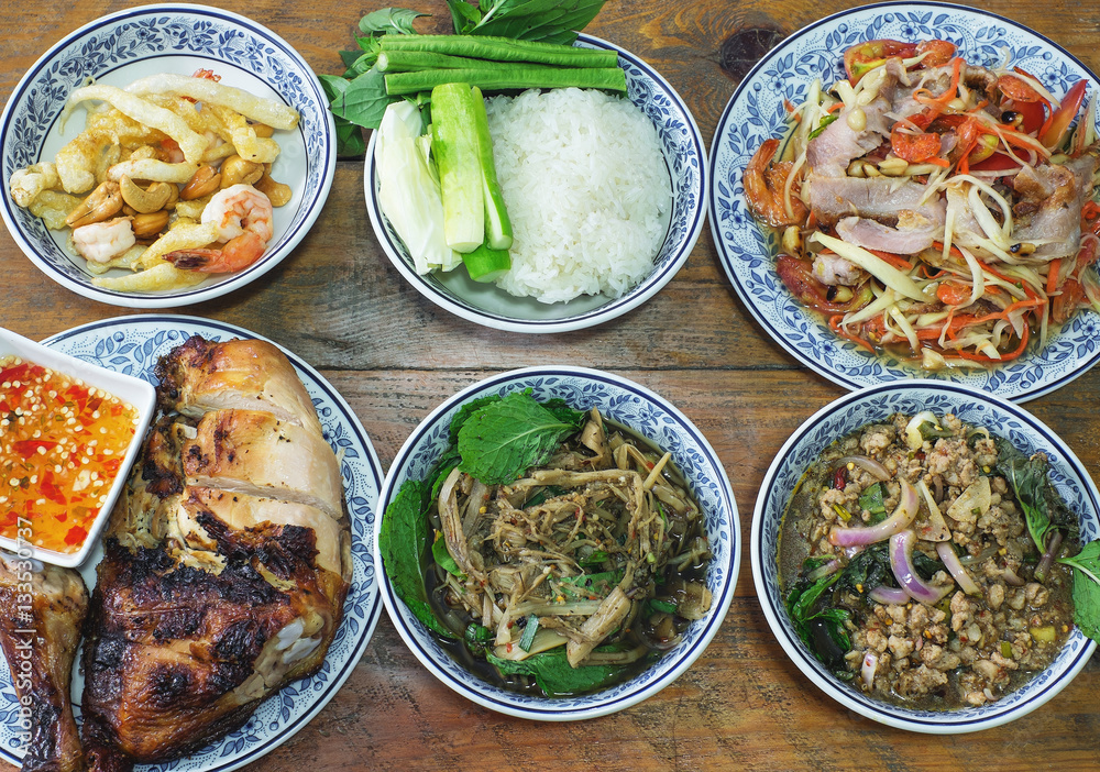 set of thai food, spicy salad, roasted chicken, sticky rice