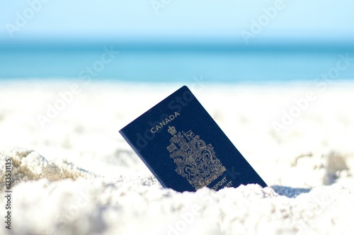 Canadian Passport in the Sand at the Beach
