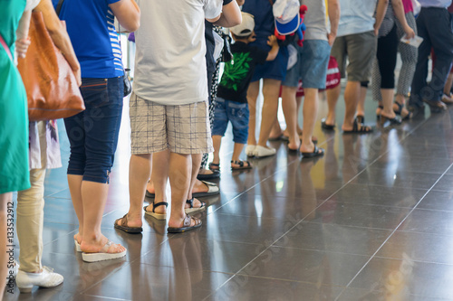 Closeup Queue of Asian people waiting at boarding gate at airport photo