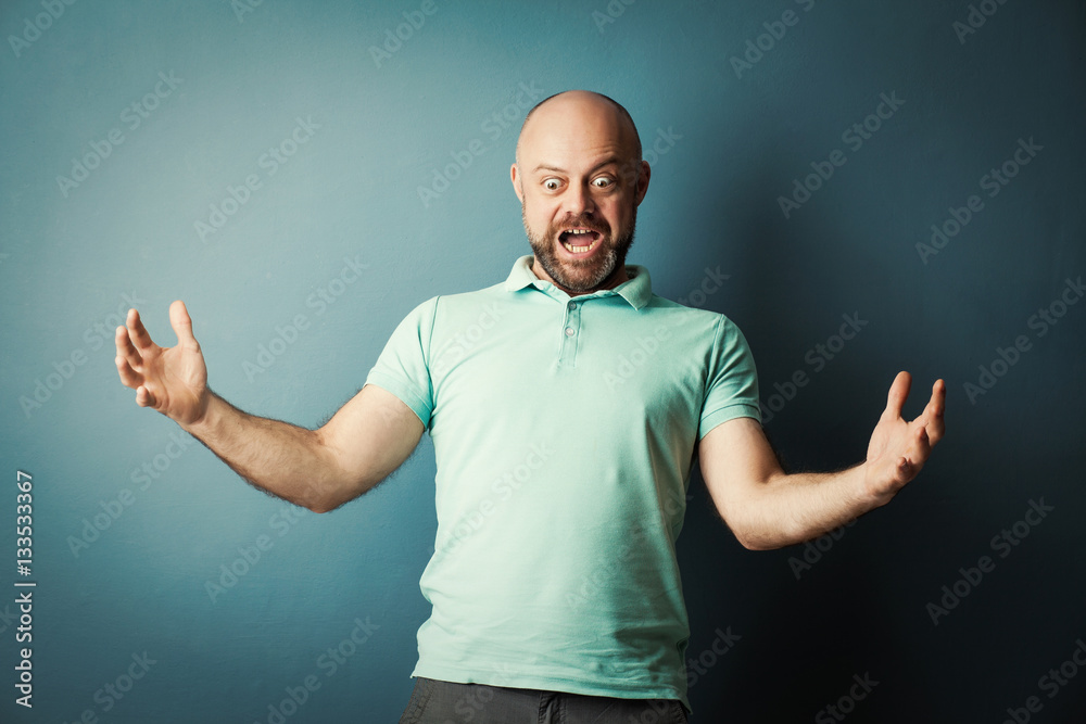 Bearded middle-aged  man making his hands the size