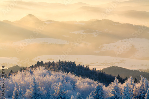 Mountain valley panorama during sunrise. Beautiful natural panoramic landscape in winter time.