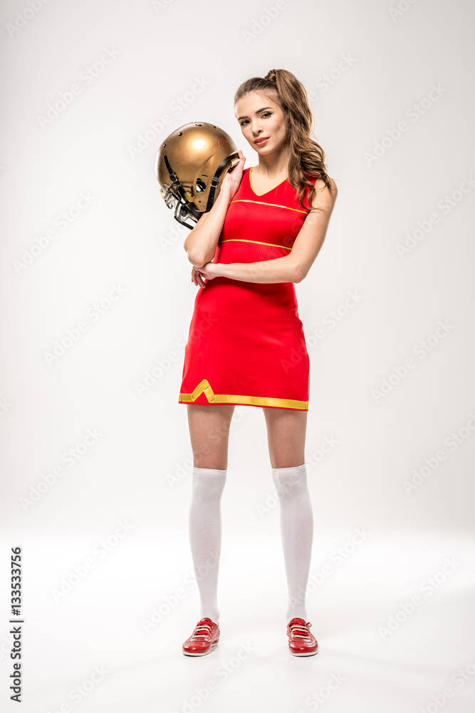 Cheerleader posing with helmet Cheerleader posing with helmet