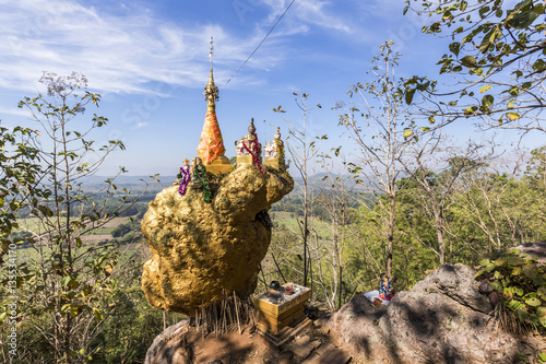 Amazing golden Buddhist pagoda on the cliff 