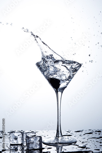 Water splash in martini glass © Poter_N