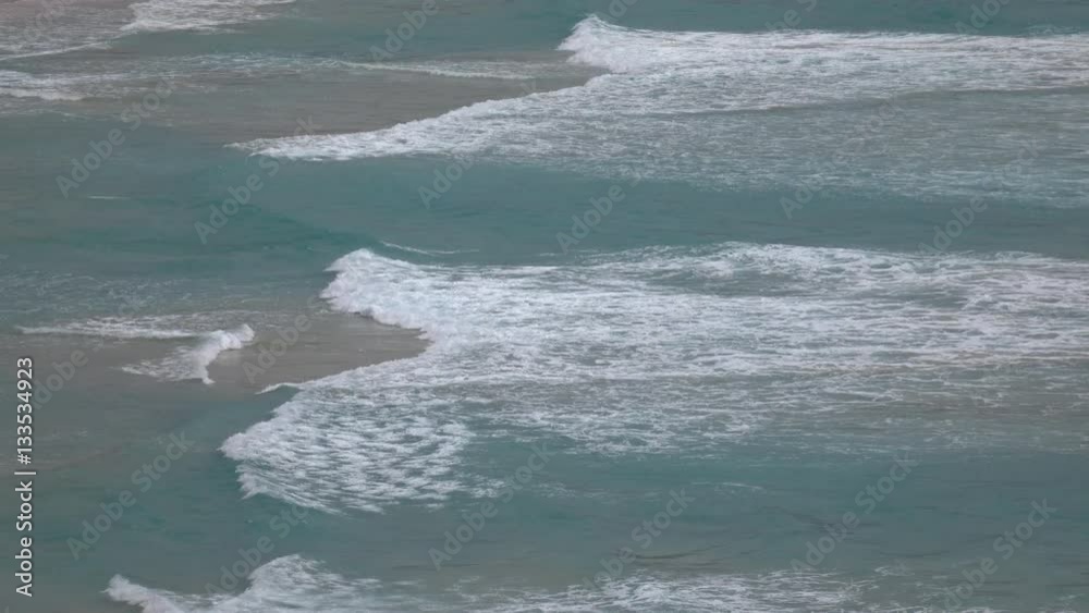 Beautiful waves crashing on sandy shore with head sea. Topside seascape ...