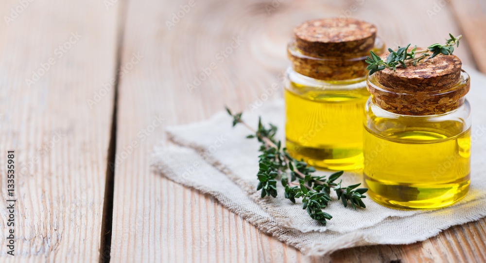 Organic essential thyme oil with green leaves Organic essential thyme oil with green leaves