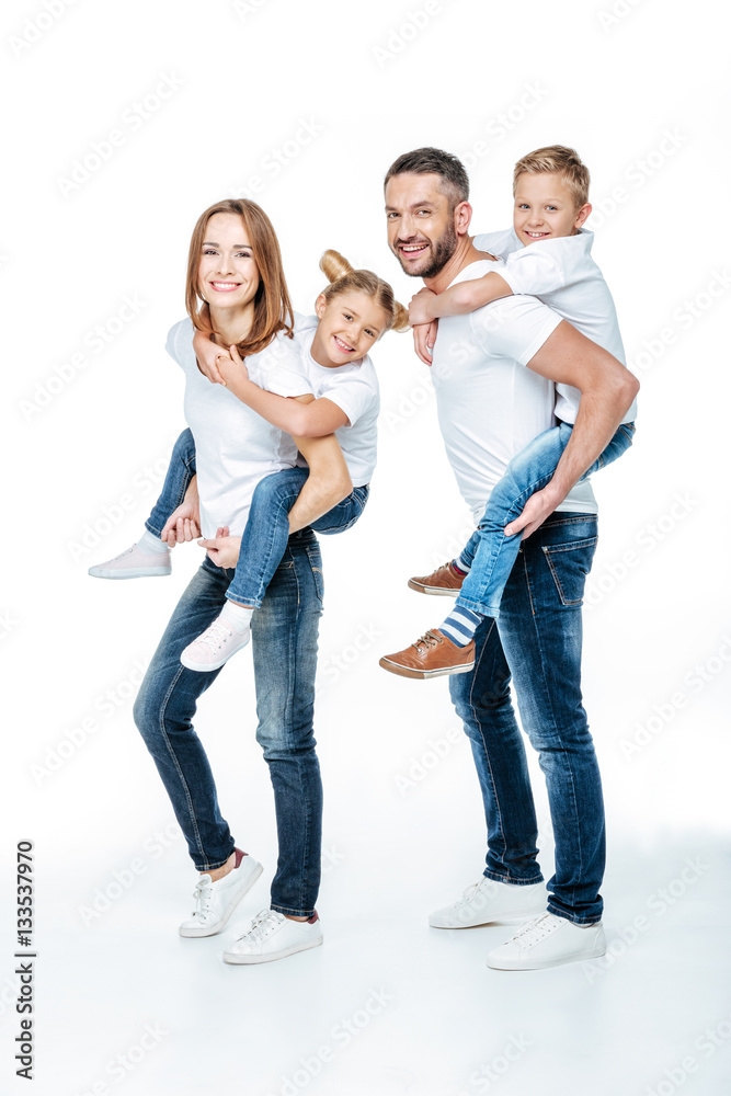 Parents piggybacking happy children Parents piggybacking happy children