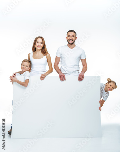 Happy family holding blank card
