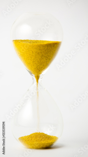 hourglass with gold beads on white background