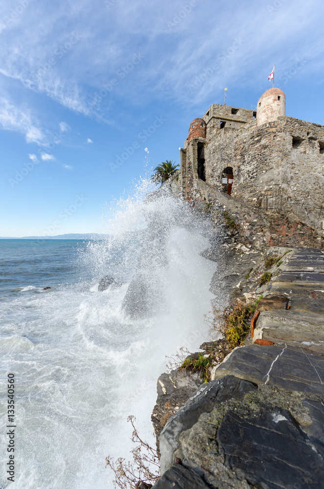 Powerful waves against the castle of Camogli