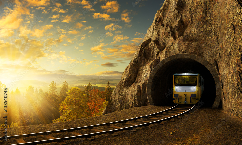 Fototapeta premium Górska kolej z pociągiem w tunelu w skale nad krajobrazem.