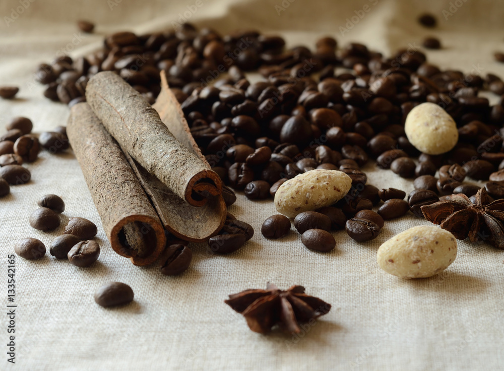 Cinnamon sticks,coffee beans,anise and almond candies still life Cinnamon sticks,coffee beans,anise and almond candies still life