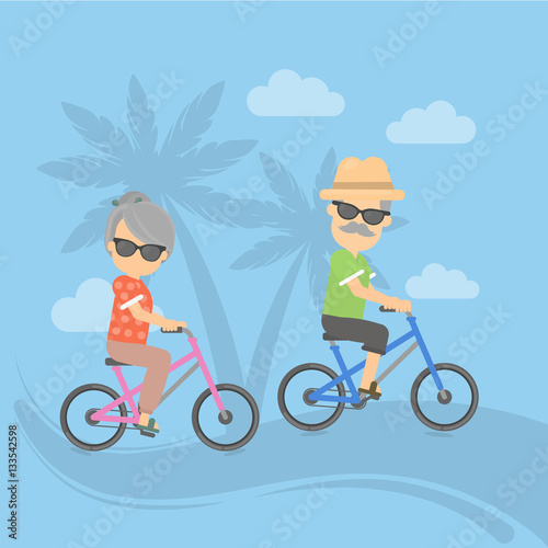 Isolated retired couple on vacation. Happy funny grandparents in sunglasses cycling on the exotic landscape.