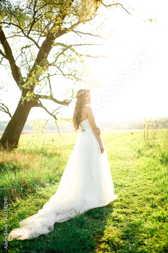 Beautiful bride in wedding dress and with a lovely mood in nature © muzhchil