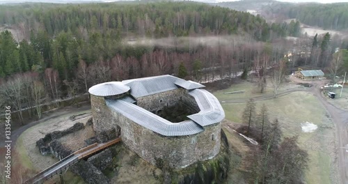 Cinema 4k aerial orbit view on Raseborg medieval castle, fortress ruins, at a cloudy autumn day, in Snappertuna, Raasepori, Finland photo