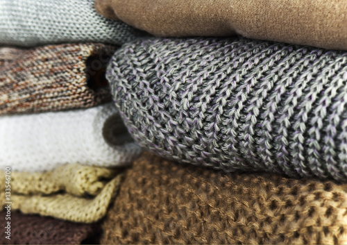 two stacks of warm sweaters on a full background horizontal