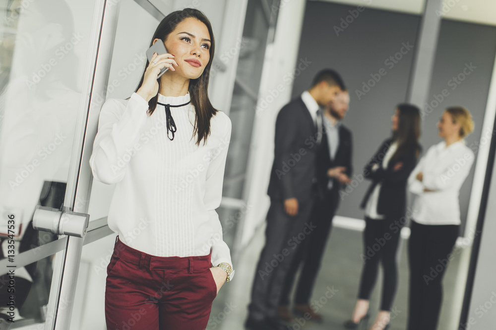 Pretty young woman with mobile phone in the office Pretty young woman with mobile phone in the office