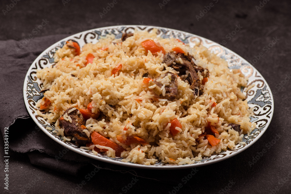 Pilaf on plate with oriental ornament. Central-Asian cuisine - Plov. Pilaf on plate with oriental ornament. Central-Asian cuisine - Plov.