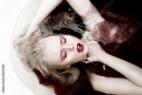 Halloween scene of an immortal female vampire in a bloody in a s